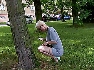 Short hair blonde solo model giving toy handjob via gloryhole