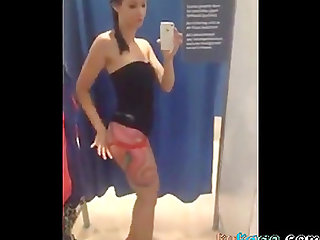 Girl with lovely slim body teasing in fitting room